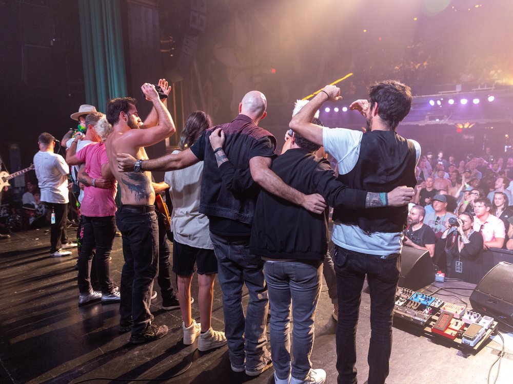 All-Star Jam musicians arm-in-arm on stage for the finale bow at the Fonda Theatre