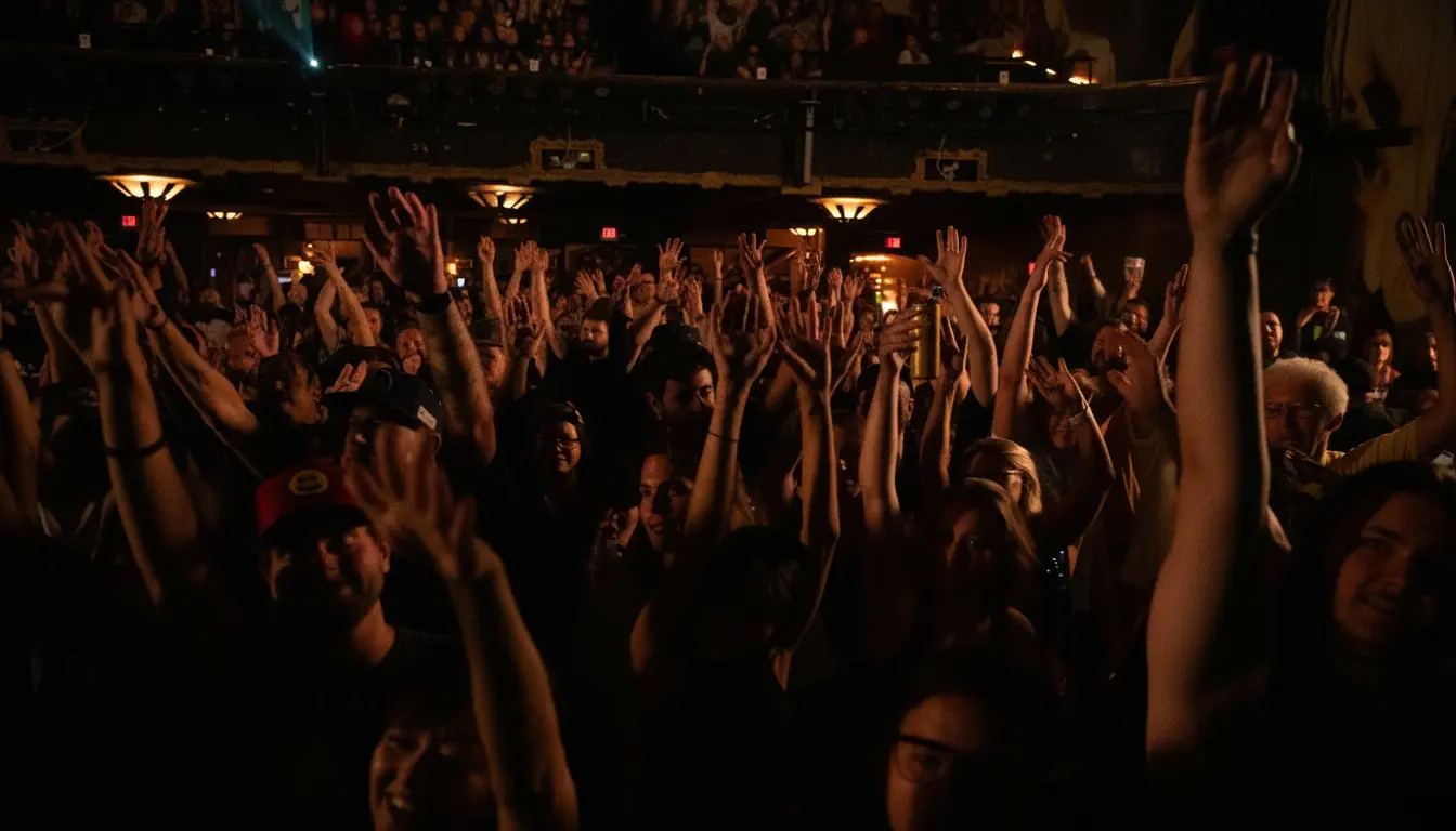 Corporate event audience with hands raised during group music session